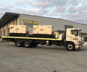 A truck with generators in front of the head office building