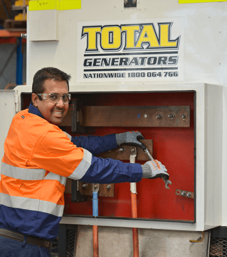 A staff is servicing a generator