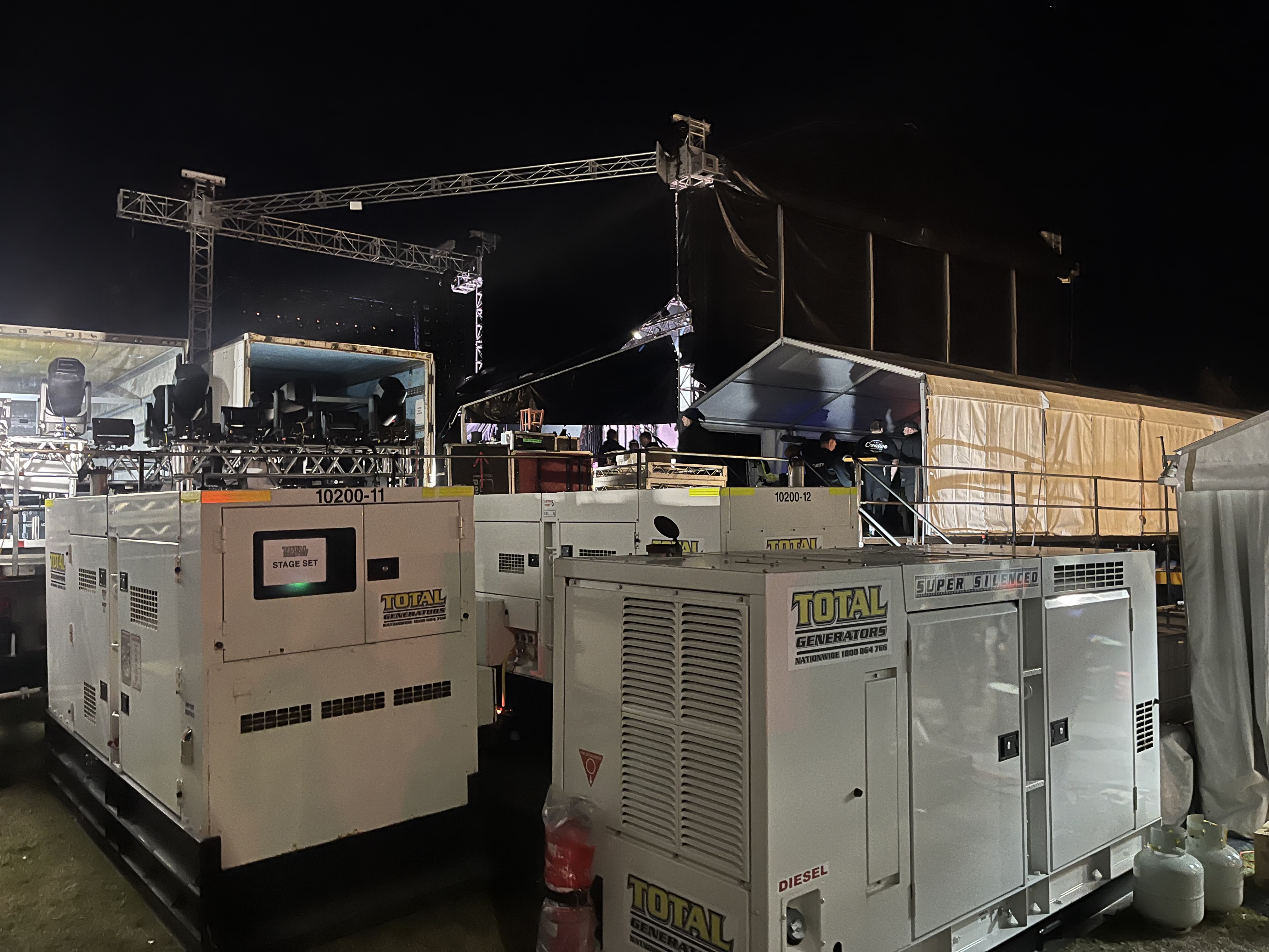 Generators backstage at an outdoor music event.